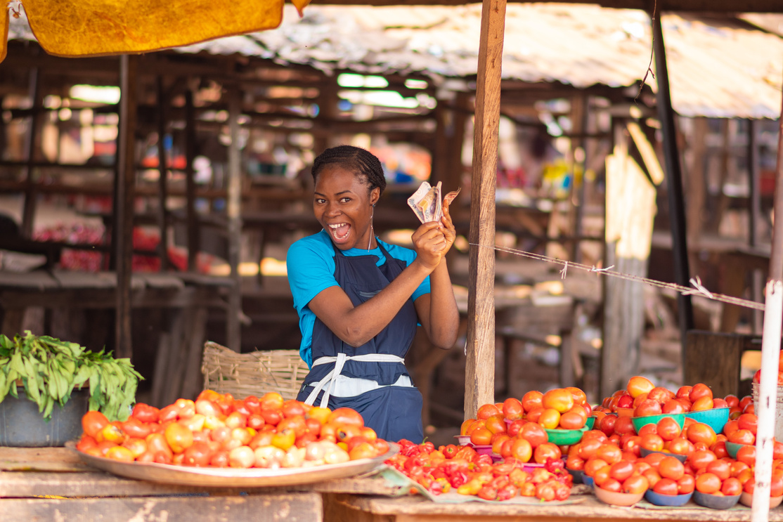 woman holding money excitedly and happy like she won a prize